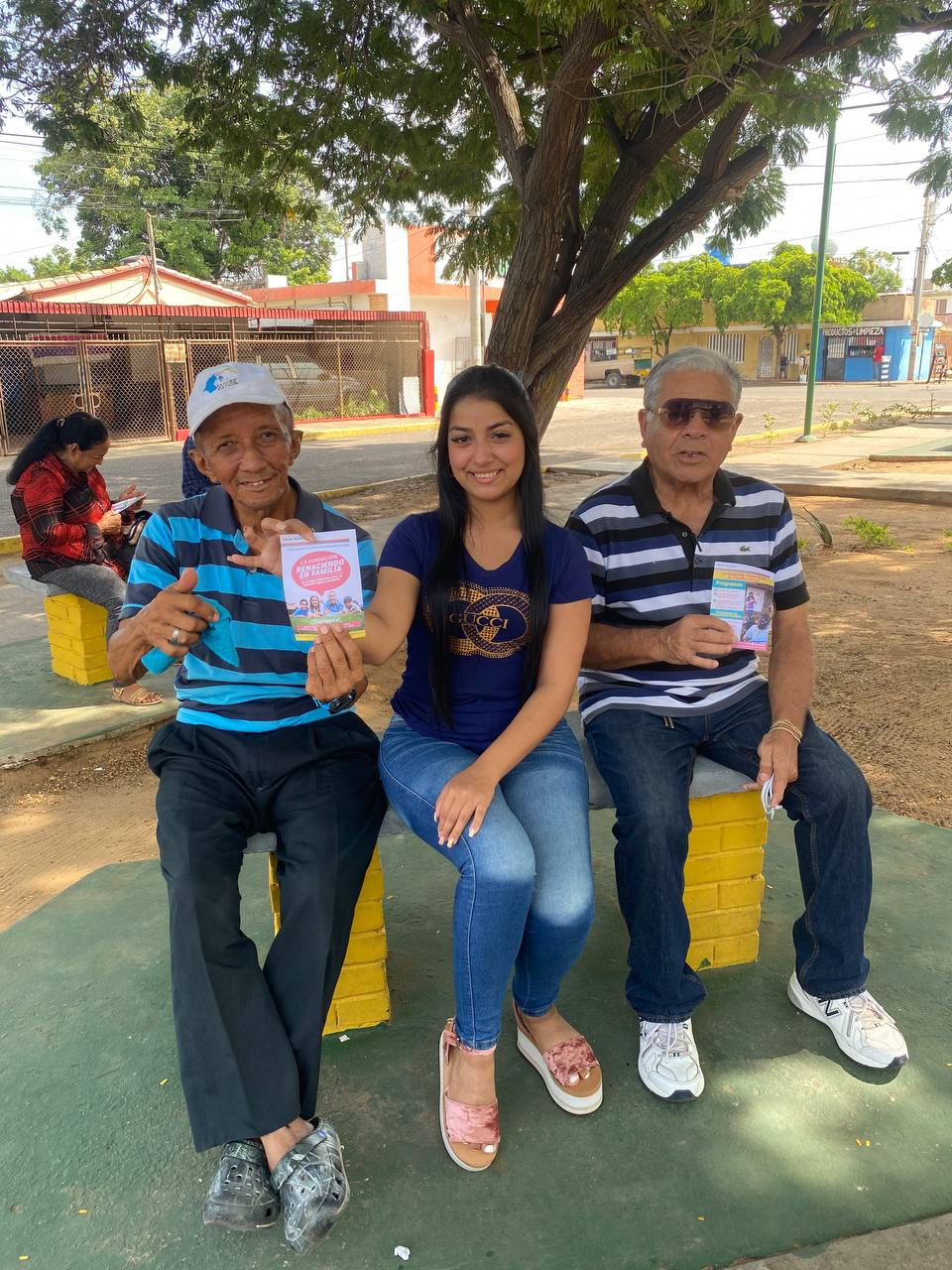 back view of woman wearing a backpack and beanie waiting to cross the road on a busy street at night in New York City, USA